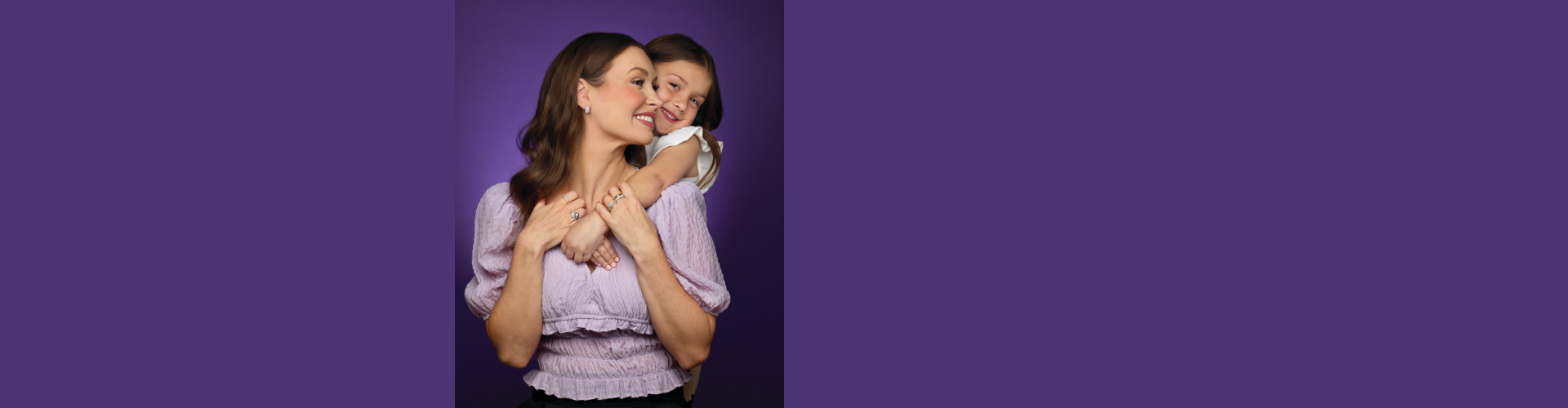 Mother and daughter embracing each other.