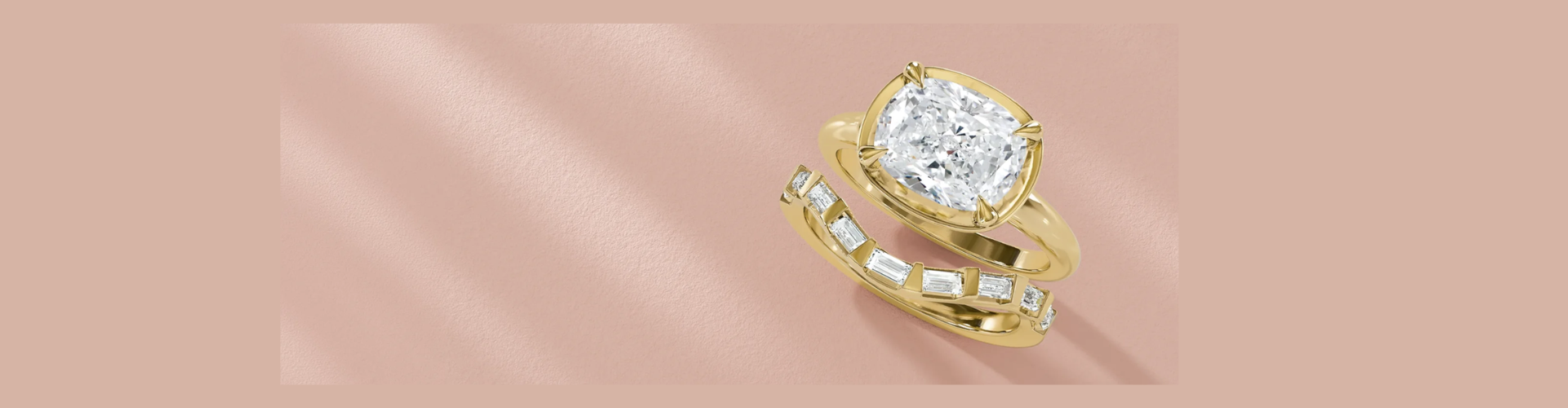 A vintage inspired diamond engagement ring and a matching baguette diamond wedding band in yellow gold.